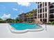 Community pool with lounge seating, and view of the apartment buildings at 6150 Gulfport S Blvd # 306, Gulfport, FL 33707