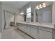 A bright primary bathroom offers double sinks, expansive counter space, and an oversized mirror at 6253 Hidden Branch Dr, Apollo Beach, FL 33572