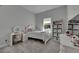 This carpeted bedroom is bright and includes two storage shelves, a dresser, and a makeup vanity at 6253 Hidden Branch Dr, Apollo Beach, FL 33572