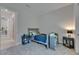 This bedroom is carpeted and includes two side tables and a view of the backyard at 6253 Hidden Branch Dr, Apollo Beach, FL 33572