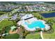 Overhead shot of the resort-style pool, clubhouse, and playground surrounded by lush landscaping and homes at 6253 Hidden Branch Dr, Apollo Beach, FL 33572