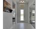 Bright foyer with light-colored flooring, a coat rack, and view of the home at 6253 Hidden Branch Dr, Apollo Beach, FL 33572