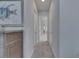 Clean, carpeted hallway with fresh paint, creating a bright and inviting pathway through the home at 6253 Hidden Branch Dr, Apollo Beach, FL 33572