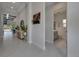 Inviting hallway featuring neutral colors, eye-catching decor, and access to a conveniently located half-bathroom at 6253 Hidden Branch Dr, Apollo Beach, FL 33572