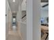 The hallway is bright, offering hardwood floors and views into other rooms of the house at 6253 Hidden Branch Dr, Apollo Beach, FL 33572