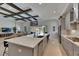 Open kitchen with island, stainless appliances, and view to living room and backyard at 6253 Hidden Branch Dr, Apollo Beach, FL 33572