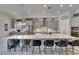 Modern kitchen features gray cabinets, stainless steel appliances, a large island with bar seating, and ample counter space at 6253 Hidden Branch Dr, Apollo Beach, FL 33572