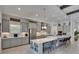 Modern kitchen with stainless steel appliances, quartz countertops, and an island with seating at 6253 Hidden Branch Dr, Apollo Beach, FL 33572