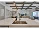 Modern kitchen featuring a large island with a sink and open floorplan to the living room, perfect for entertaining at 6253 Hidden Branch Dr, Apollo Beach, FL 33572