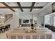 Spacious living room with modern decor, coffered ceilings, and seamless flow to the outdoor living area at 6253 Hidden Branch Dr, Apollo Beach, FL 33572