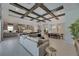 Open-concept living room with coffered ceilings, kitchen with an island, and dining room at 6253 Hidden Branch Dr, Apollo Beach, FL 33572