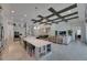 Expansive open-concept living room featuring a modern kitchen, dining area, and comfortable seating area with a TV at 6253 Hidden Branch Dr, Apollo Beach, FL 33572