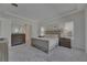 This is a spacious carpeted primary bedroom featuring a tray ceiling, dual nightstands, and matching dresser at 6253 Hidden Branch Dr, Apollo Beach, FL 33572