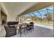 Screened in outdoor seating with views of the pool, complete with dining table and comfortable seating at 6253 Hidden Branch Dr, Apollo Beach, FL 33572