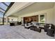 Expansive covered outdoor living space with comfortable seating and views of the pool at 6253 Hidden Branch Dr, Apollo Beach, FL 33572