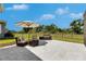 Outdoor patio area with comfortable seating and an umbrella, perfect for relaxing or entertaining at 6253 Hidden Branch Dr, Apollo Beach, FL 33572