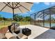 Outdoor patio area with seating and view of the pool and backyard; perfect for relaxing or entertaining at 6253 Hidden Branch Dr, Apollo Beach, FL 33572