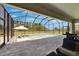 Screened-in pool area with an umbrella and lounge chairs, perfect for relaxation and entertainment at 6253 Hidden Branch Dr, Apollo Beach, FL 33572