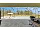 Screened-in pool area featuring a lounging area, an umbrella, and an outdoor dining space at 6253 Hidden Branch Dr, Apollo Beach, FL 33572