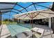 A covered, screened pool with loungers and a lounge area, offering a perfect outdoor living space at 6253 Hidden Branch Dr, Apollo Beach, FL 33572