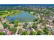 Stunning aerial view of a lakeside community surrounded by lush greenery and neighborhood homes at 701 Millifold Pl, Brandon, FL 33510