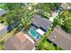 Aerial view of home featuring pool and deck, large lawn, mature trees, and fenced perimeter at 701 Millifold Pl, Brandon, FL 33510