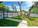 Spacious fenced backyard with a pool and patio area, with mature trees adding shade at 701 Millifold Pl, Brandon, FL 33510