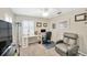 Bright bedroom featuring desk, office chair, recliner, ceiling fan, and window with plantation shutters at 701 Millifold Pl, Brandon, FL 33510