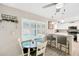 Cozy breakfast nook features plantation shutters and seating at the kitchen bar at 701 Millifold Pl, Brandon, FL 33510