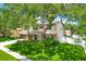 Charming two-story home with a well-manicured lawn and mature trees providing ample shade at 701 Millifold Pl, Brandon, FL 33510