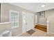 Inviting foyer with tile flooring, a bright white front door, and adjacent stairway at 701 Millifold Pl, Brandon, FL 33510