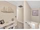 Bright hallway features neutral walls, artwork, console table and carpeted floor at 701 Millifold Pl, Brandon, FL 33510