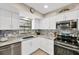 Bright kitchen boasts stainless steel appliances, granite countertops, and a stylish tile backsplash at 701 Millifold Pl, Brandon, FL 33510