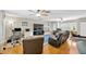 Large living room with hardwood floors, ceiling fans and natural light at 701 Millifold Pl, Brandon, FL 33510