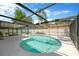 Inviting in-ground pool inside screened enclosure, with dining and lounging area and lush backyard at 701 Millifold Pl, Brandon, FL 33510