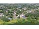 Scenic aerial view of a lakeside community with lush green landscapes, beautiful homes, and serene water views at 709 Sportsman Park Dr, Seffner, FL 33584