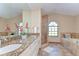 Elegant bathroom featuring granite countertops, double sinks, a separate shower and a soaking tub at 709 Sportsman Park Dr, Seffner, FL 33584