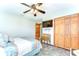 Spacious bedroom includes closet with paneled doors, ceiling fan, mounted TV, and stylish tile flooring at 709 Sportsman Park Dr, Seffner, FL 33584