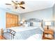 Charming bedroom features a decorative metal bed frame, ceiling fan, warm paint color and wood-look flooring at 709 Sportsman Park Dr, Seffner, FL 33584