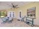 Inviting covered patio with seating, a large ceiling fan, and tiled floors for relaxation and entertainment at 709 Sportsman Park Dr, Seffner, FL 33584