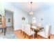 Cozy dining area with hardwood floors, chandelier lighting, and upholstered seating at 709 Sportsman Park Dr, Seffner, FL 33584