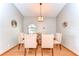 Bright dining room with hardwood floors, a chandelier, and comfortable upholstered chairs at 709 Sportsman Park Dr, Seffner, FL 33584