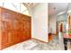 Inviting foyer featuring wood double doors, tile flooring, and a view into the dining area at 709 Sportsman Park Dr, Seffner, FL 33584