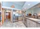 Bright kitchen with stainless steel appliances, custom cabinets, and a seamless flow into the dining area at 709 Sportsman Park Dr, Seffner, FL 33584