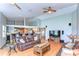 Open-concept living room showcasing hardwood floors, vaulted ceilings, and seamless flow into kitchen at 709 Sportsman Park Dr, Seffner, FL 33584
