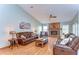 Spacious living room with hardwood floors, a brick fireplace, and ample natural light at 709 Sportsman Park Dr, Seffner, FL 33584