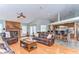Open-concept living room flowing into the kitchen, featuring hardwood floors and a cozy brick fireplace at 709 Sportsman Park Dr, Seffner, FL 33584