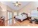 Bright primary bedroom with hardwood floors, high ceilings, and a private balcony at 709 Sportsman Park Dr, Seffner, FL 33584