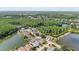 Aerial view of homes in community situated between two lakes and mature trees at 7235 Sharpsburg Blvd, New Port Richey, FL 34653