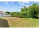 Spacious backyard with lush greenery and partial fence; perfect for outdoor enjoyment at 7235 Sharpsburg Blvd, New Port Richey, FL 34653